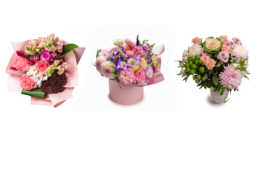 Pink and purple bouquet of flowers in a pink box isolated on white background.