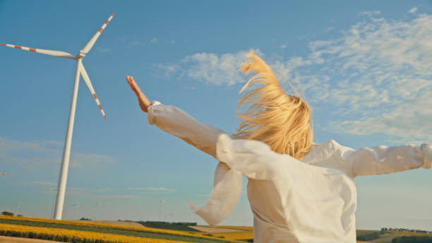 istock Lady Running with Excitement to Windmill on Farm 2025394669