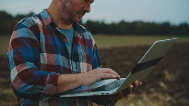 istock Agronomist Using Laptop While Standing On Agricultural Field 2025400542