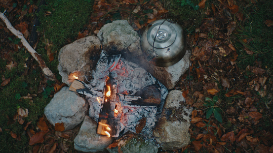 From a High Vantage Point,Wood Crackles and Burns amidst the Rocks of the Campfire,Casting a Warm Glow and Adding to the Enchanting Ambiance of the Forest.