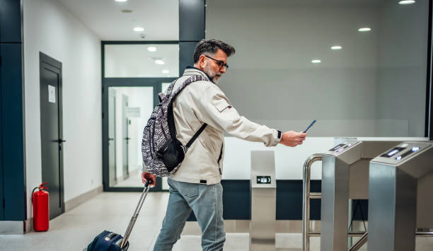 istock Mature man passing through turnstile at train station 2025407085