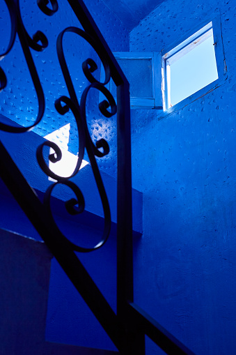 Blue interior with staircase and window in Chefchaouen, Morocco, North Africa.