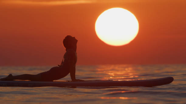 istock Active Woman Practicing Yoga on Paddleboard in Ocean during Sunset 2025416303