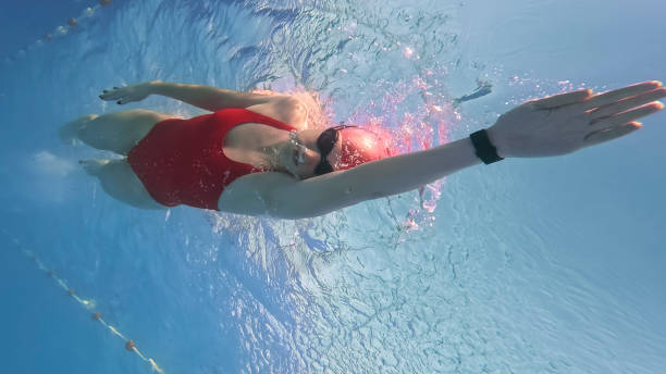 istock Woman in Red Swimsuit Refining Swimming Techniques at Resort Pool 2025417404