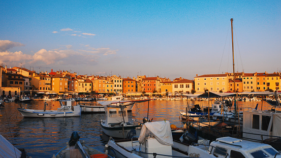 Boats Moored at Harbor against Sky during Sunset. Tranquil Backdrop of the City's Skyline,where Buildings Stand as Sentinels of Urban Life. Picturesque Scene that Blends the Serenity of the Sea with the Vibrant Energy of Old Town.