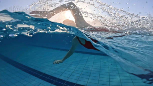 istock Skilled Female Splashing Water While Swimming at Resort Pool 2025418525