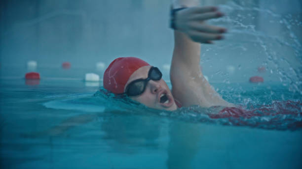 In the Peaceful Atmosphere of a Misty Dawn,a Skilled Female Swimmer Honing Her Strokes,Demonstrating Perseverance and Dedication in Her Training at the Resort's Tranquil Pool.