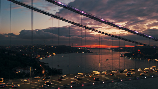 Amidst the Soft Glow of Twilight,Vehicles Traverse the Illuminated Bosphorus Bridge,Spanning the Expanse of the Marmara Sea against a Backdrop of Cloudy Skies in Istanbul,Turkey. This Captivating Scene Captures the Bustling Energy of the City