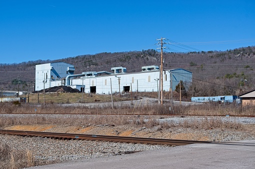 Factory building with train tracks in the foreground