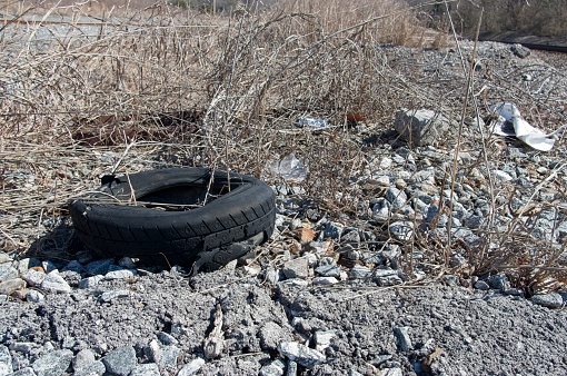 Old worn out tire abandoned in a gravelled area