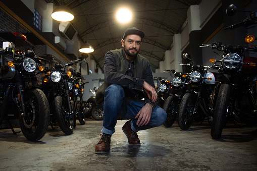 Portrait of man in garage motorcycle shop