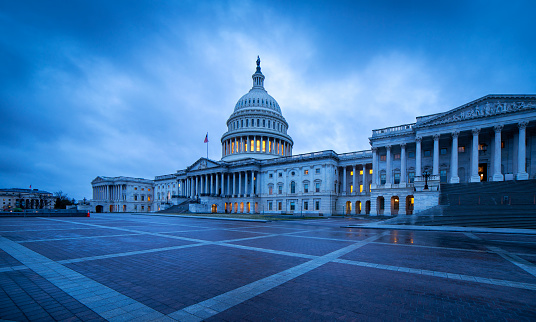 Capitol hill building at night illuminated with light, Washington DC.