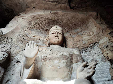Buddha image in Cave 4 at Yungang Grottoes, ancient Chinese Buddhist temple grottoes built during the Northern Wei dynasty near the city of Datong, in the province of Shanxi. They are excellent examples of rock-cut architecture and one of the three most famous ancient Buddhist sculptural sites of China. The others are Longmen and Mogao.