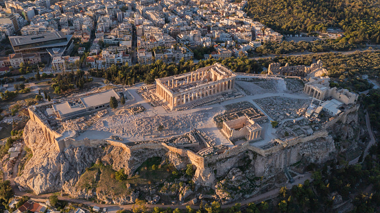 Elevated, panoramic view of the illuminated Acropolis of Athens, Greece, with the Parthenon Temple and the old town Plaka during dusk