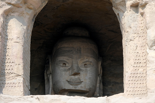 Giant Buddha niche at Yungang Grottoes, ancient Chinese Buddhist temple grottoes built during the Northern Wei dynasty near the city of Datong, in the province of Shanxi. They are excellent examples of rock-cut architecture and one of the three most famous ancient Buddhist sculptural sites of China. The others are Longmen and Mogao.