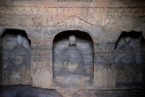 Stone Buddha niches at Yungang Grottoes, ancient Chinese Buddhist temple grottoes built during the Northern Wei dynasty near the city of Datong, in the province of Shanxi. They are excellent examples of rock-cut architecture and one of the three most famous ancient Buddhist sculptural sites of China. The others are Longmen and Mogao.