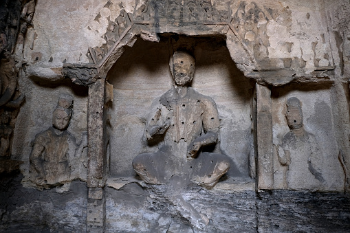 Stone Buddhas at Yungang Grottoes, ancient Chinese Buddhist temple grottoes built during the Northern Wei dynasty near the city of Datong, in the province of Shanxi. They are excellent examples of rock-cut architecture and one of the three most famous ancient Buddhist sculptural sites of China. The others are Longmen and Mogao.