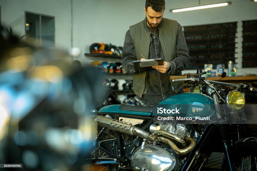 Motorcycle Repairing Notes Man Takes Note On Motorcycles Stock Photo - Download Image Now - Auto ...