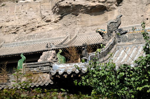 Architecture at Yungang Grottoes, ancient Chinese Buddhist temple grottoes built during the Northern Wei dynasty near the city of Datong, in the province of Shanxi. They are excellent examples of rock-cut architecture and one of the three most famous ancient Buddhist sculptural sites of China. The others are Longmen and Mogao.