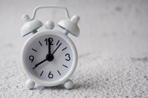 istock White alarm clock pointing at 8am with customizable space for text. Copy space 2025475273