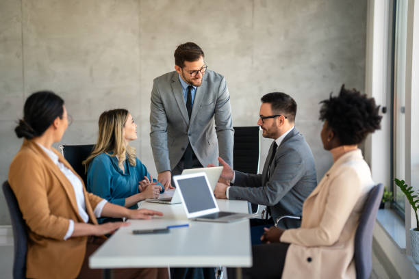 istock Multicultural professional businesspeople working together on research plan in boardroom. 2025555143