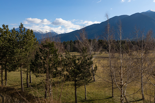 Snowy mountain peak and cloudy sky in February. Nature background, global warming, care for the planet. Pirin mountain is the highest mountain in Bulgaria with Musala peak -2925m.