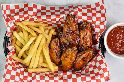 babacue wings served with   a side of french fries