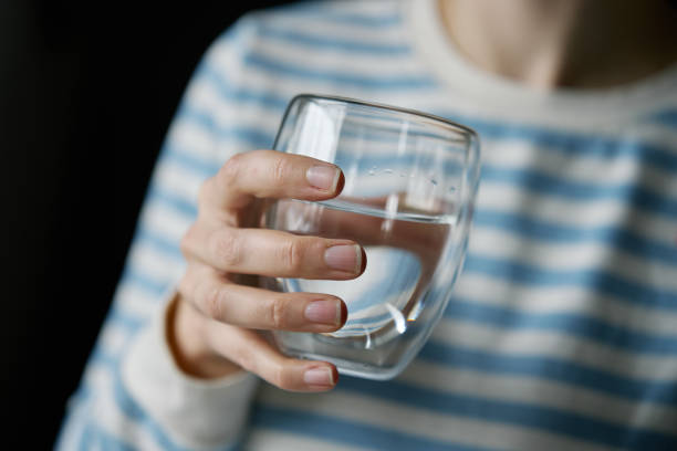 istock Woman drinks clean water from glass 2025599838