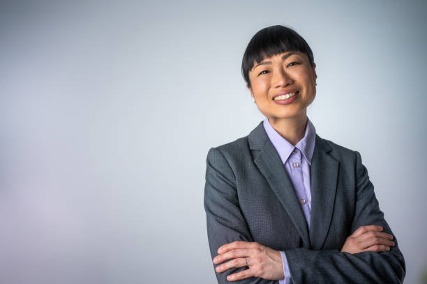 istock Confident Japanese Woman Against Gray Background 2025640637