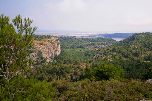 The Massif de la Clape is an upland area consisting of pine forest, garrigue and vineyards, with many hiking routes, bridle paths and mountain bike trails.  This headland gives views over the village of Gruissan and the Mediterranean Sea in the far distance.