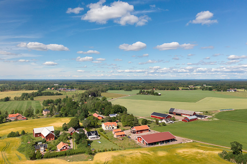 A countryside landscape in Västergötland, Sweden, with a village, farms and fields.