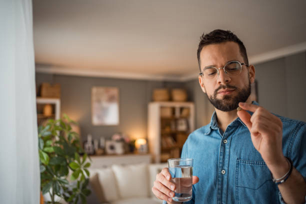istock The young man takes medication to reduce depression or headaches 2025715910
