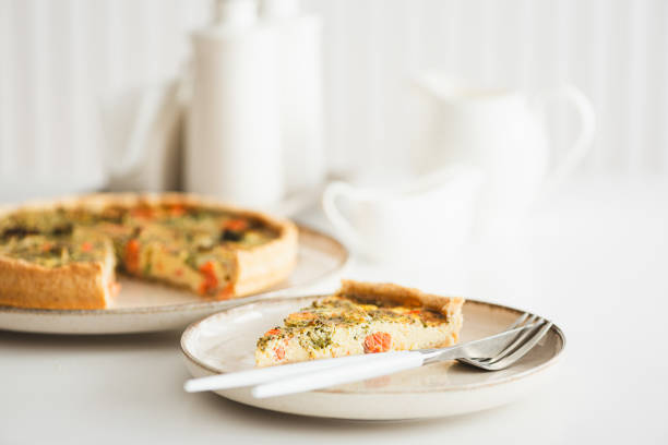 istock French quiche lauren with salmon, cheese and broccoli on white table. Soft focus 2025765916