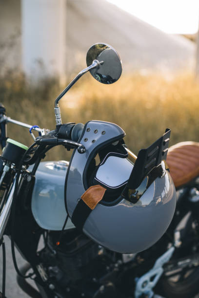 istock Motorcyclist's crash-helmet hanging on the handle of a motorcycle. 2025773708