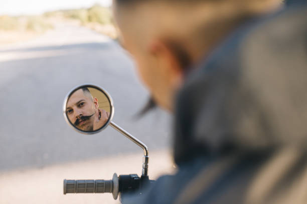 istock Biker man is reflected in the mirror of his motorcycle. 2025775295