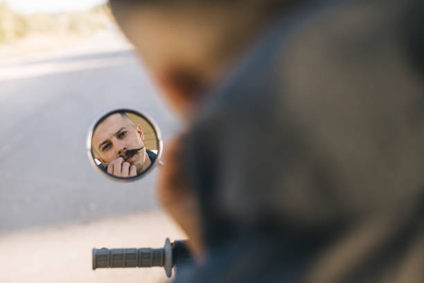 istock Biker man is reflected in the mirror of his motorcycle. 2025775298