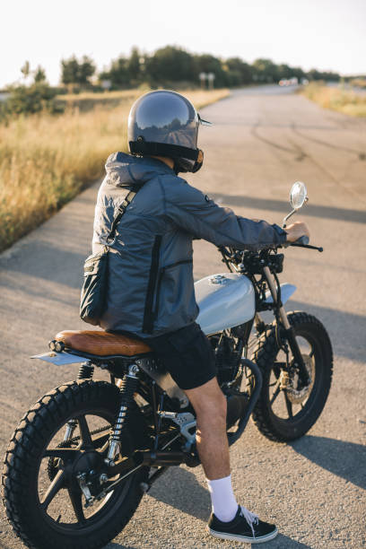 istock Driver riding motorcycle on an asphalt road in highway at sunset. 2025777856