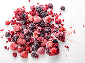 Frozen berry fruit. Bunch of frozen berry fruit background pattern. Mixed Berries. Close up of frozen mixed fruit - berries.