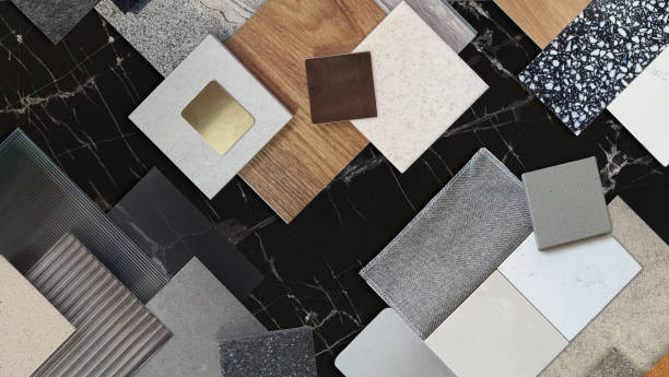 istock interior material samples contains panels and tiles. interior moodboard including terrazzo, quartz, stone tiles, blue laminated, wooden flooring tiles, gold stainless placed on black marble table. 2025788901