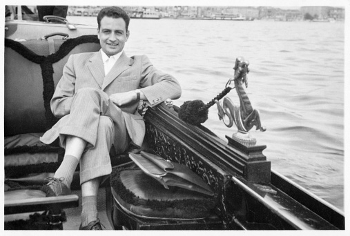 Young man sitting on a gondola in Venice. 1941.