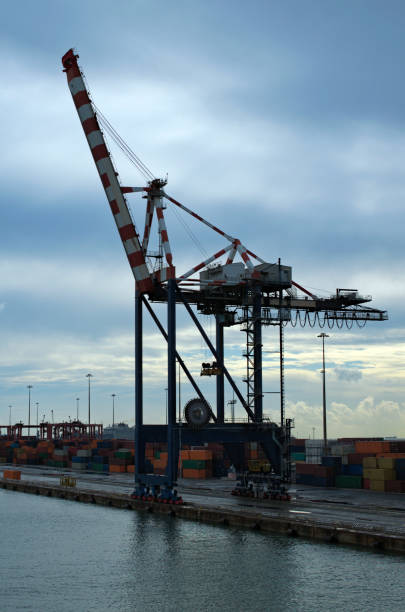 istock Landscape view of crane bridge for unloading or loading containers to the cargo freight ship from port area. Import, export and business logistic. International water transport 2025818933