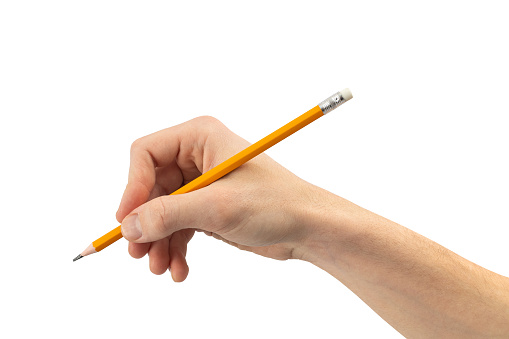 A hand poised to write with a classic yellow pencil isolated on white.