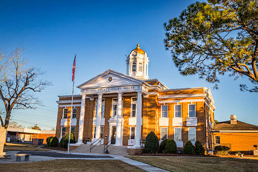 Front view of the historic Evans County Courthouse in Claxton, Georgia. The courthouse was built in 1923 and added to the National Register of Historic Places in 1980.
