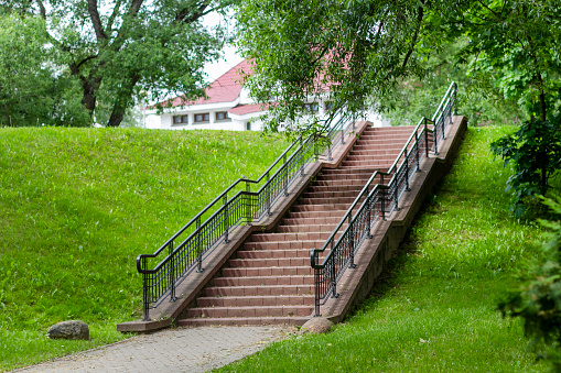Park landscape. Beautiful staircase with railings in the park on a summer day