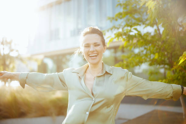 istock smiling modern woman worker near office building rejoicing 2025859869