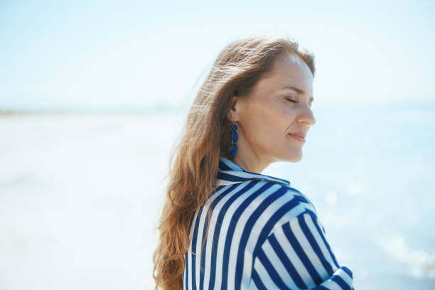 istock relaxed modern woman on seashore enjoying tranquility 2025867724