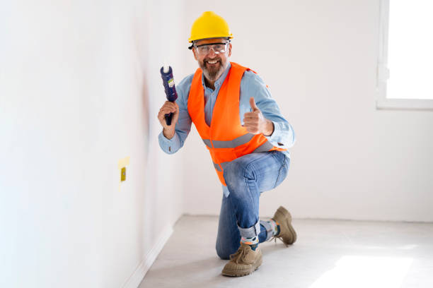 istock A man installs a floor skirting board 2025883312
