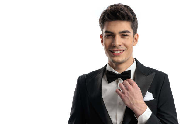 istock elegant happy man in black tuxedo smiling while adjusting black bowtie 2025894822