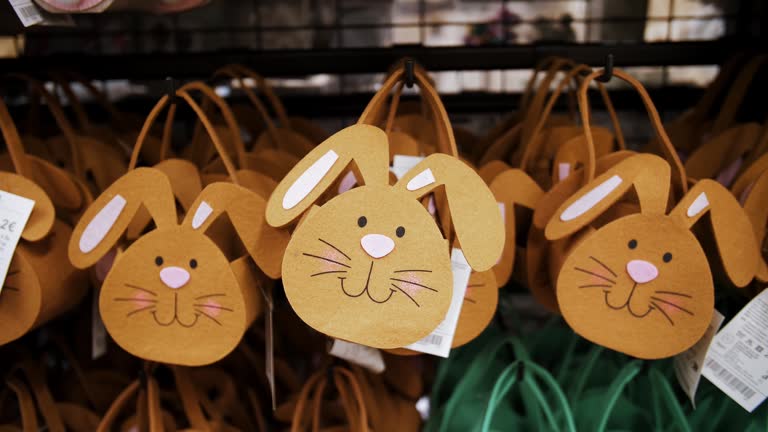 Easter sale. shopping of Easter decorations and gifts for home in the shop. decorative, Easter gift felt bunny bags, on a display in a store. Catholic Easter