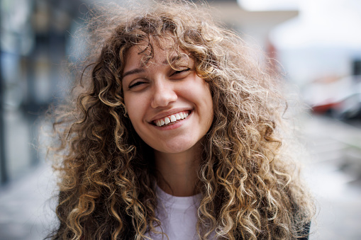 Portrait of beautiful, smiling curly hair woman
